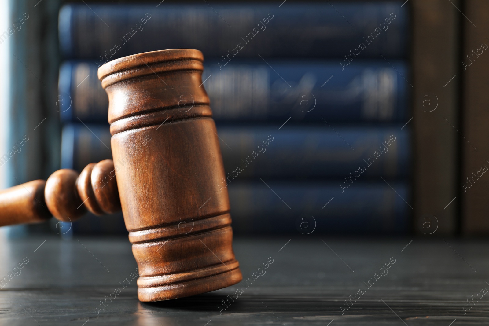 Photo of Wooden gavel on dark table, closeup. Law concept
