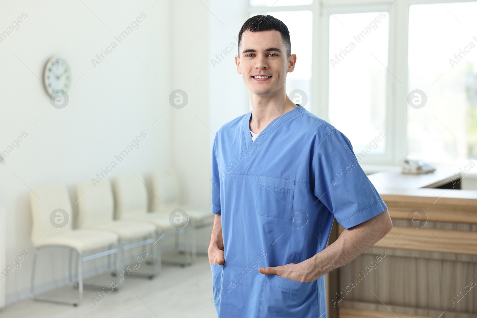 Photo of Portrait of smiling medical assistant in hospital. Space for text