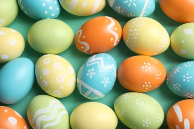 Photo of Many beautiful painted Easter eggs as background, top view