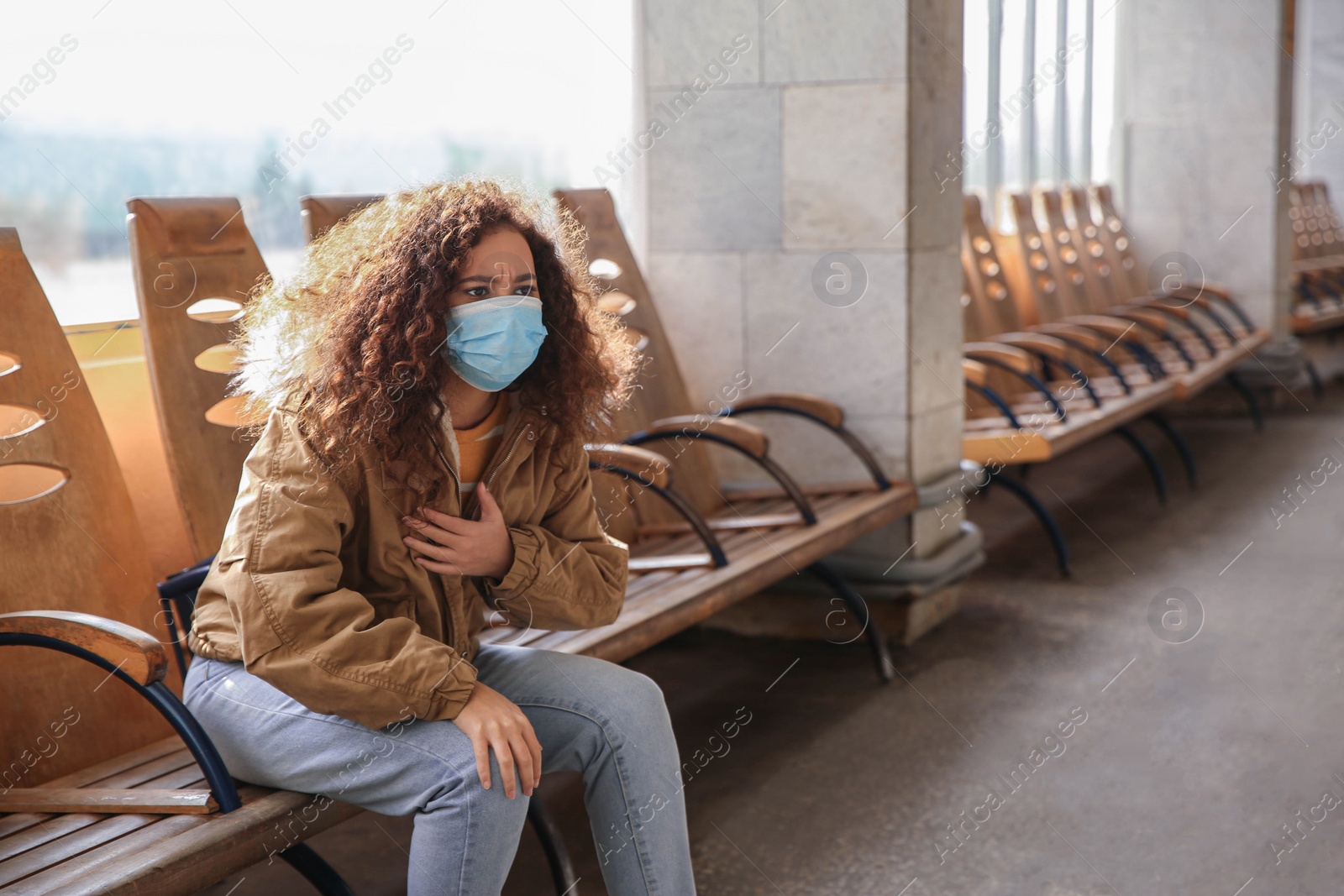 Photo of African-American woman with disposable mask indoors. Virus protection