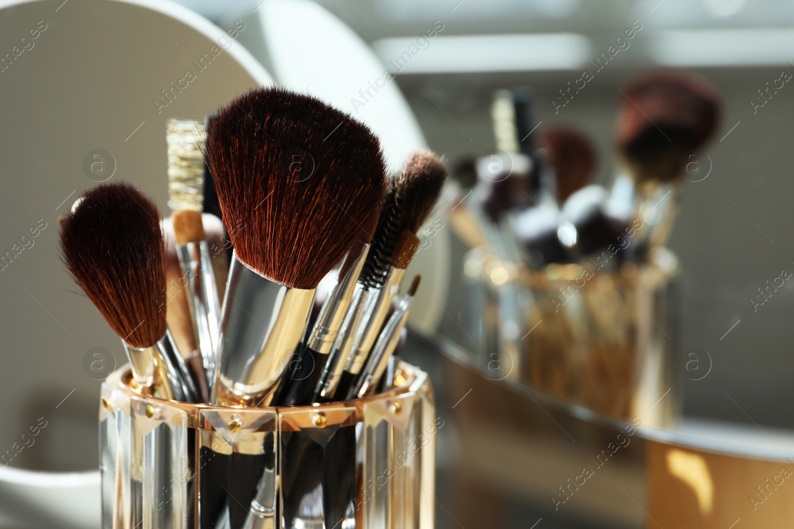 Photo of Set of professional brushes and mirror, closeup. Space for text