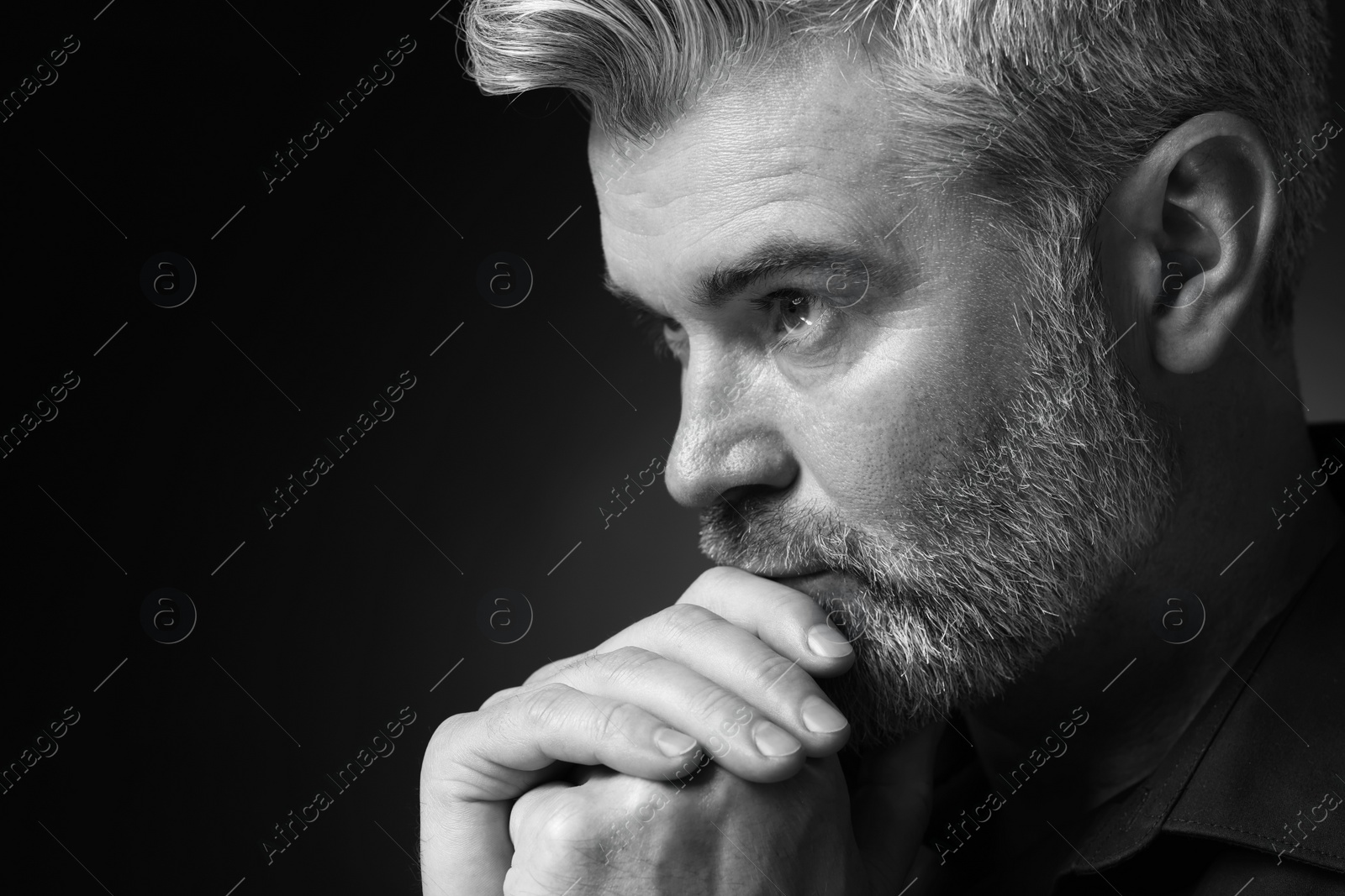 Photo of Portrait of handsome man on dark background, space for text. Black and white effect