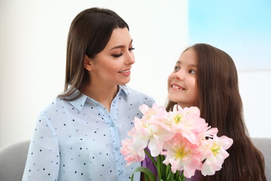 Little daughter congratulating her mom at home. Happy Mother's Day