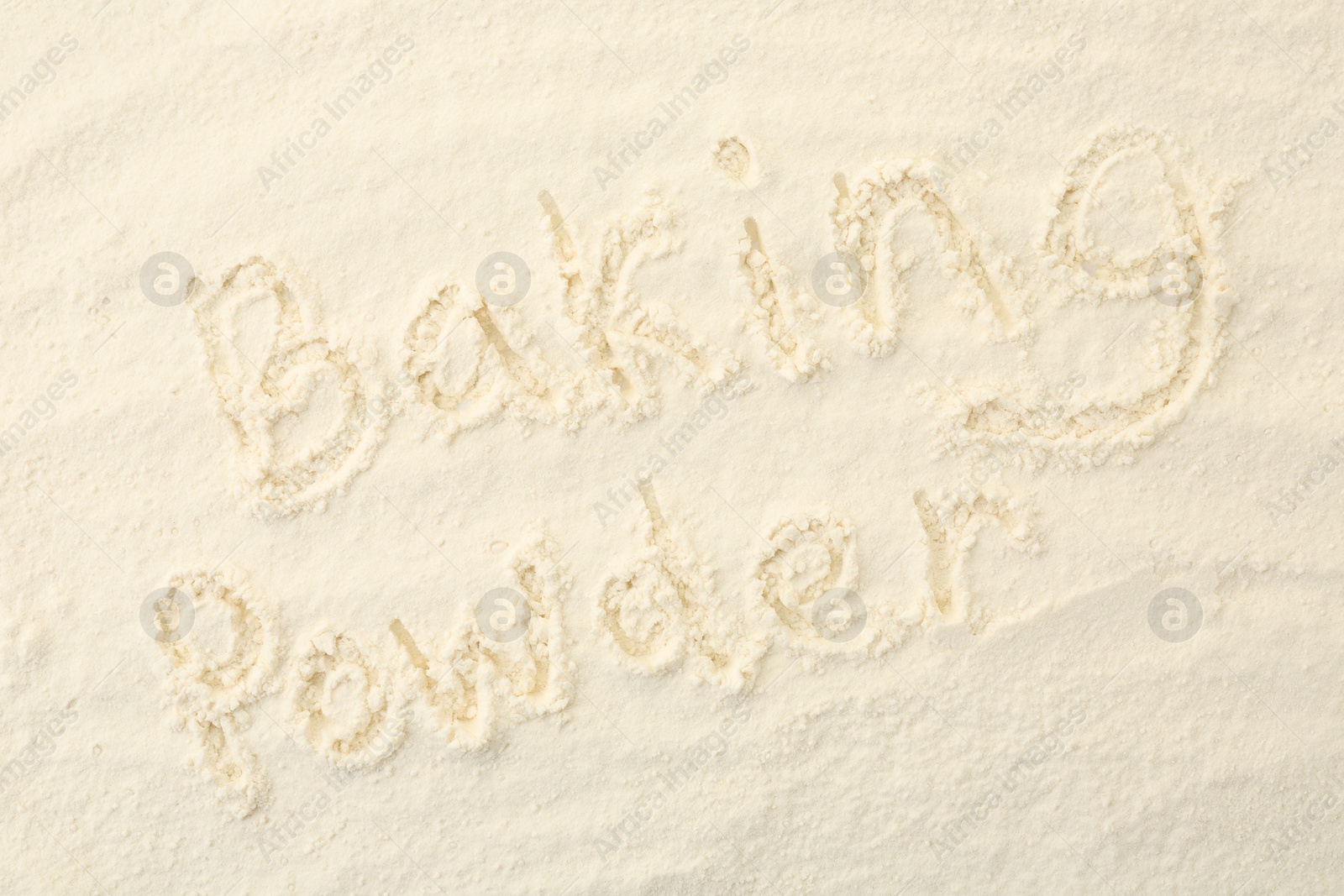 Photo of Words Baking Powder written on powder, top view