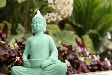 Photo of Decorative Buddha statue outdoors, closeup. Space for text