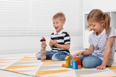 Little children playing with building blocks indoors, space for text. Wooden toys