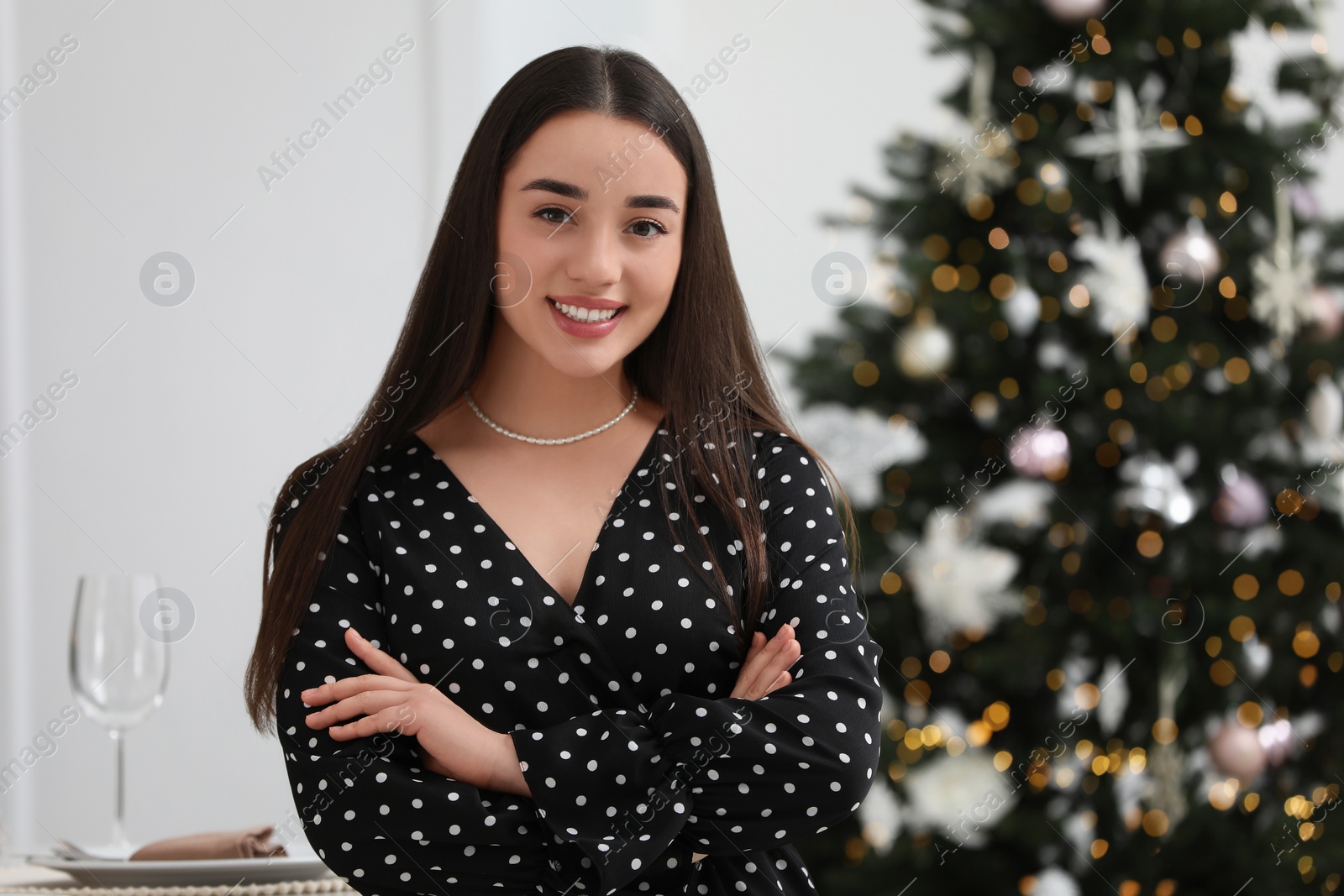 Photo of Portrait of happy woman near Christmas tree indoors