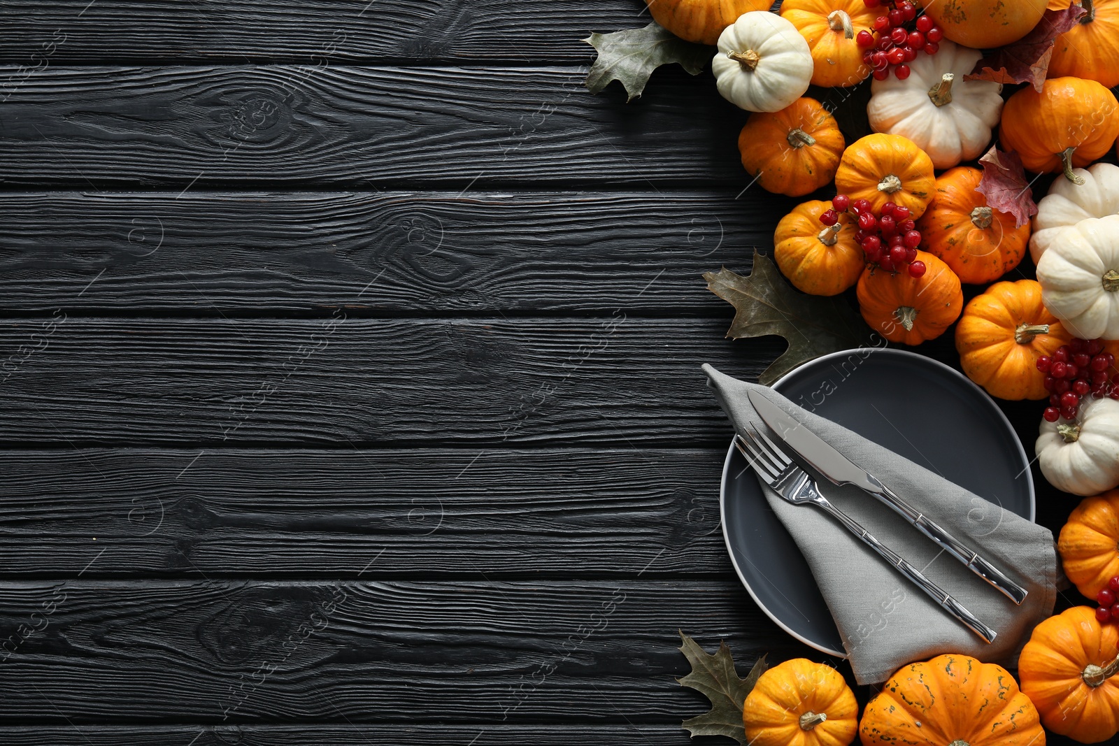 Photo of Happy Thanksgiving day. Beautiful table setting with autumn leaves, berries and pumpkins, flat lay, Space for text