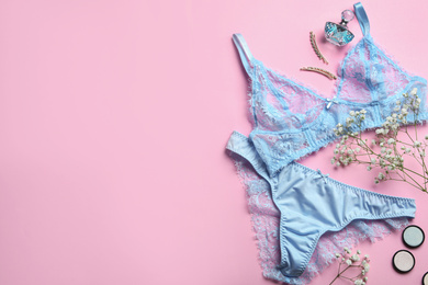 Photo of Flat lay composition with women's underwear and space for text on pink background