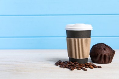 Photo of Paper cup with plastic lid, coffee beans and muffin on white wooden table, space for text. Coffee to go