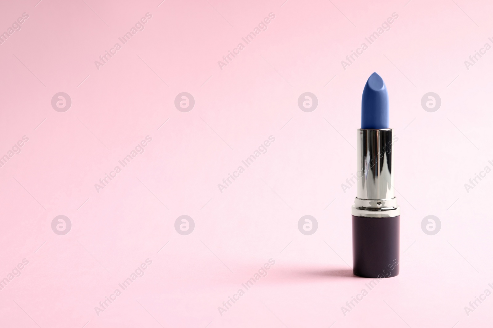 Image of Bright lipstick on pink background. Space for text