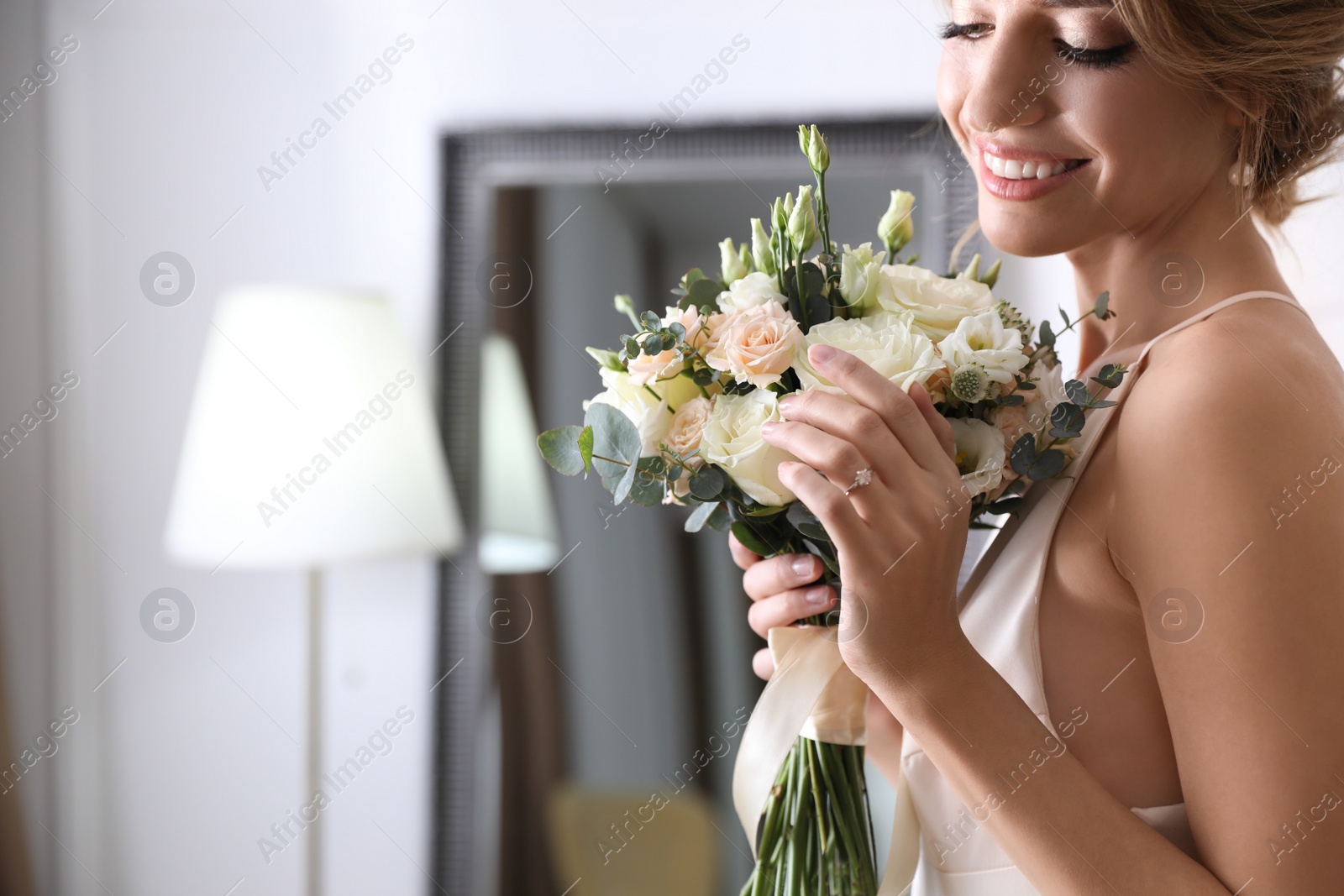 Photo of Young bride with beautiful wedding bouquet indoors