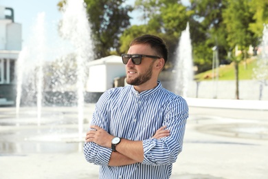 Portrait of handsome young man on street