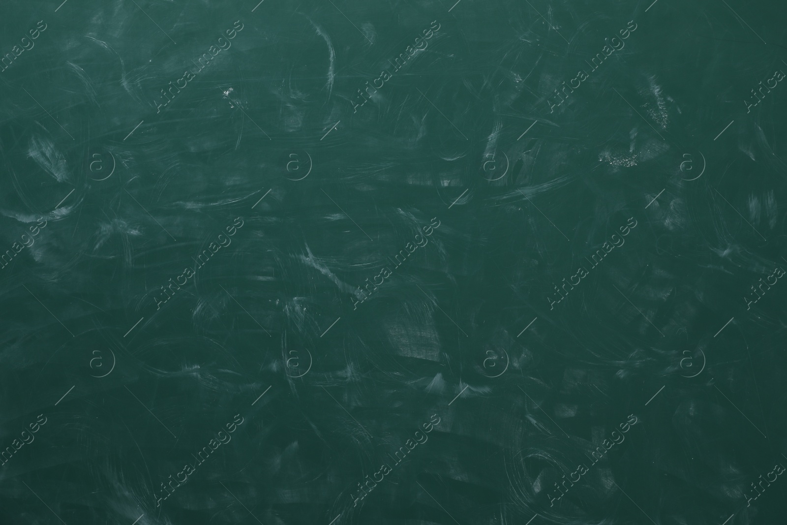 Photo of Chalk rubbed out on green chalkboard as background, closeup. Space for text