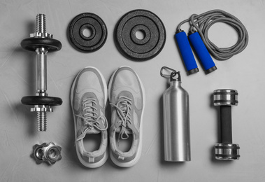 Photo of Gym equipment on light grey background, flat lay