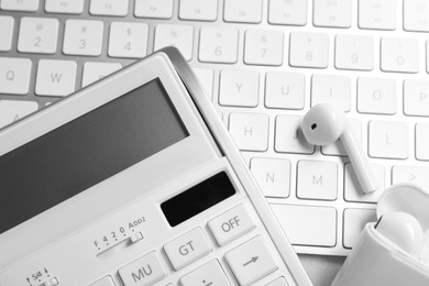 Calculator, earphones and keyboard, closeup. Tax accounting