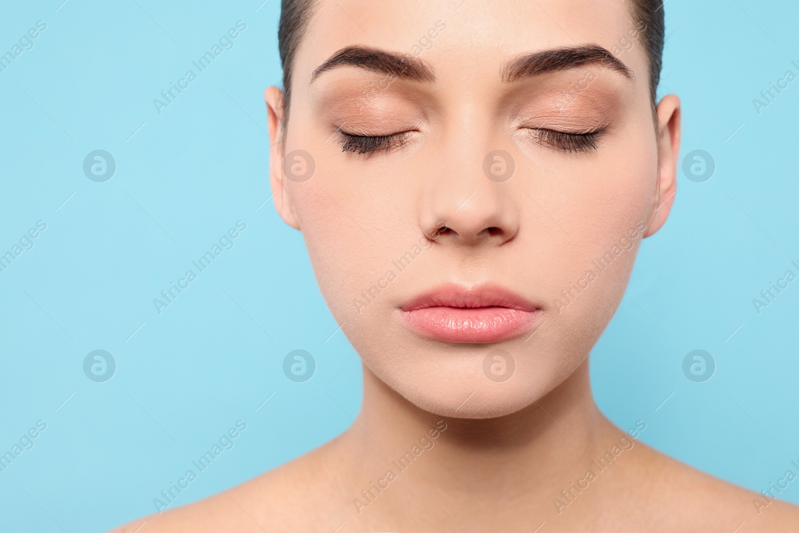 Photo of Portrait of young woman with beautiful face and natural makeup on color background, closeup. Space for text