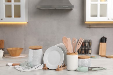 Photo of Set of different kitchenware on white table at home