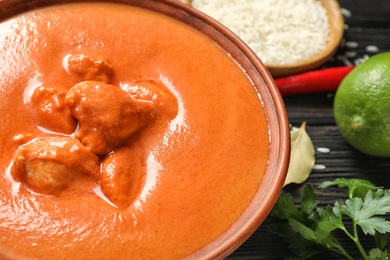 Photo of Delicious butter chicken served on table, closeup. Traditional indian Murgh Makhani