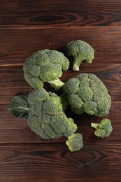 Fresh raw broccoli on wooden table, flat lay