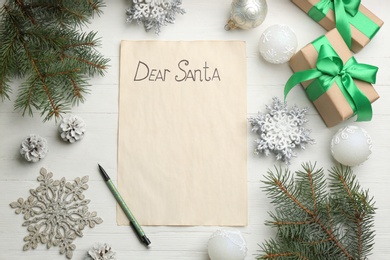 Flat lay composition with letter saying Dear Santa on white wooden table, space for text