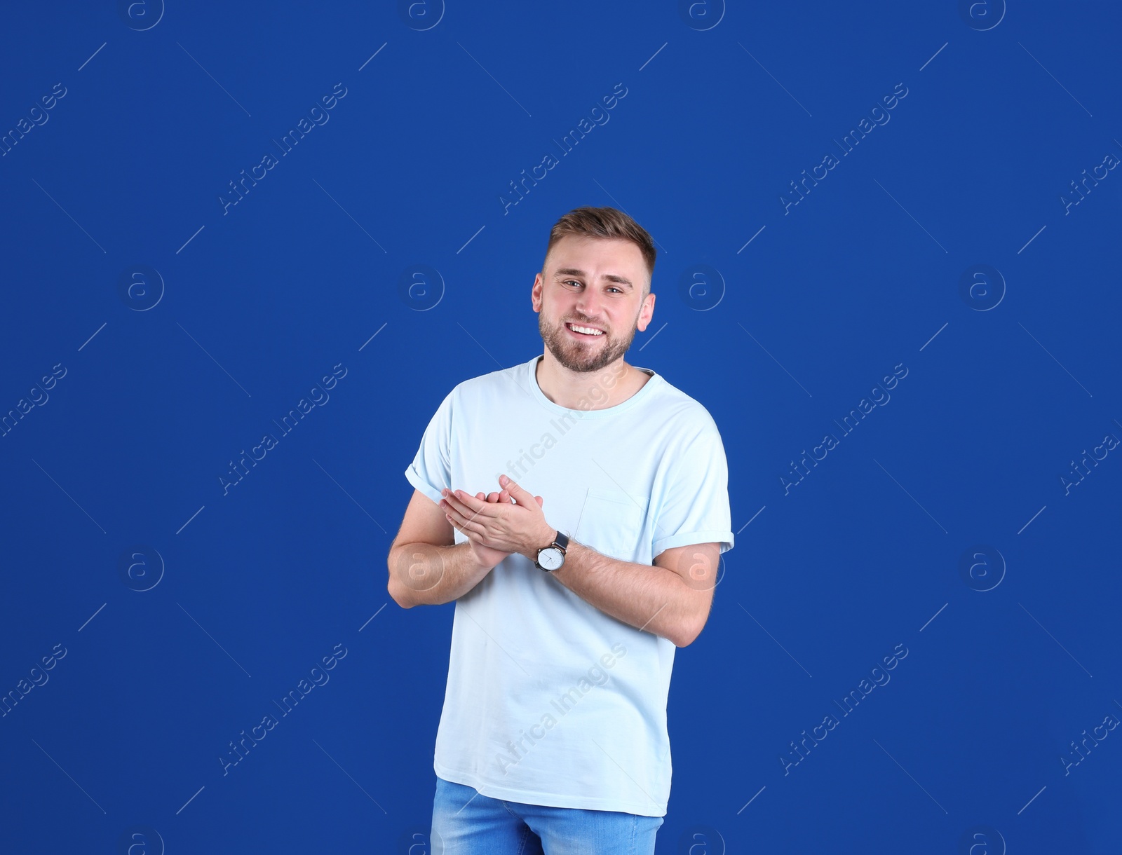 Photo of Portrait of handsome happy man on color background