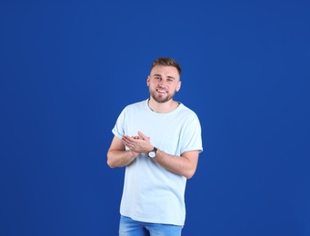 Portrait of handsome happy man on color background