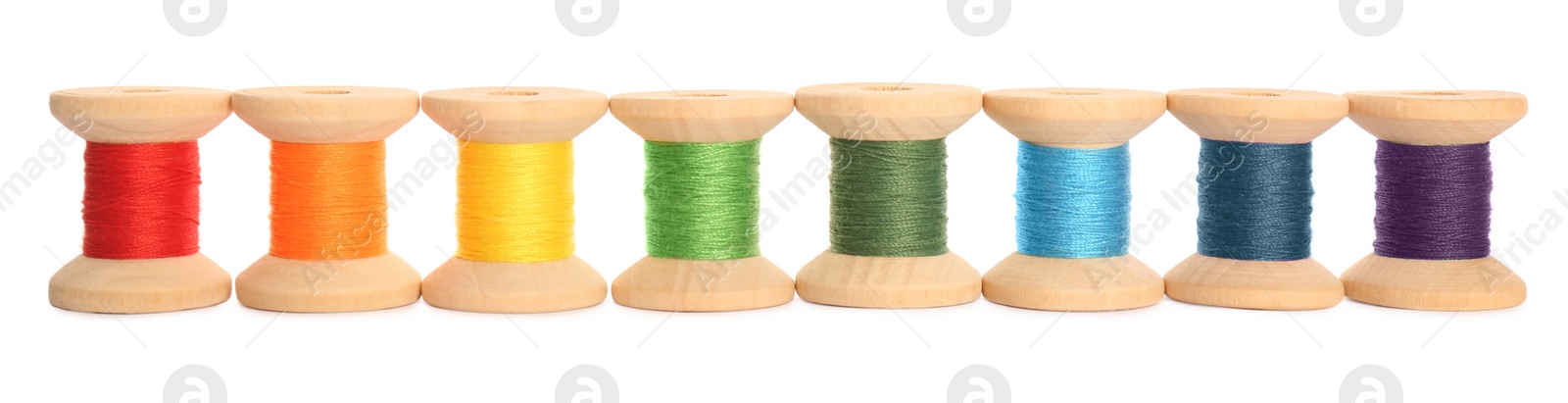 Photo of Set of colorful sewing threads on white background