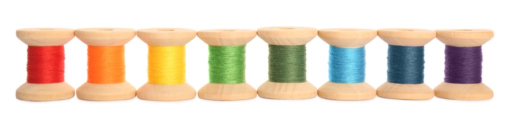 Set of colorful sewing threads on white background