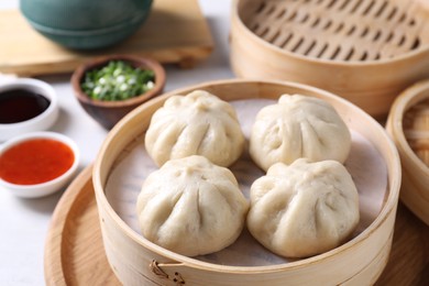 Delicious bao buns (baozi) on light table, closeup