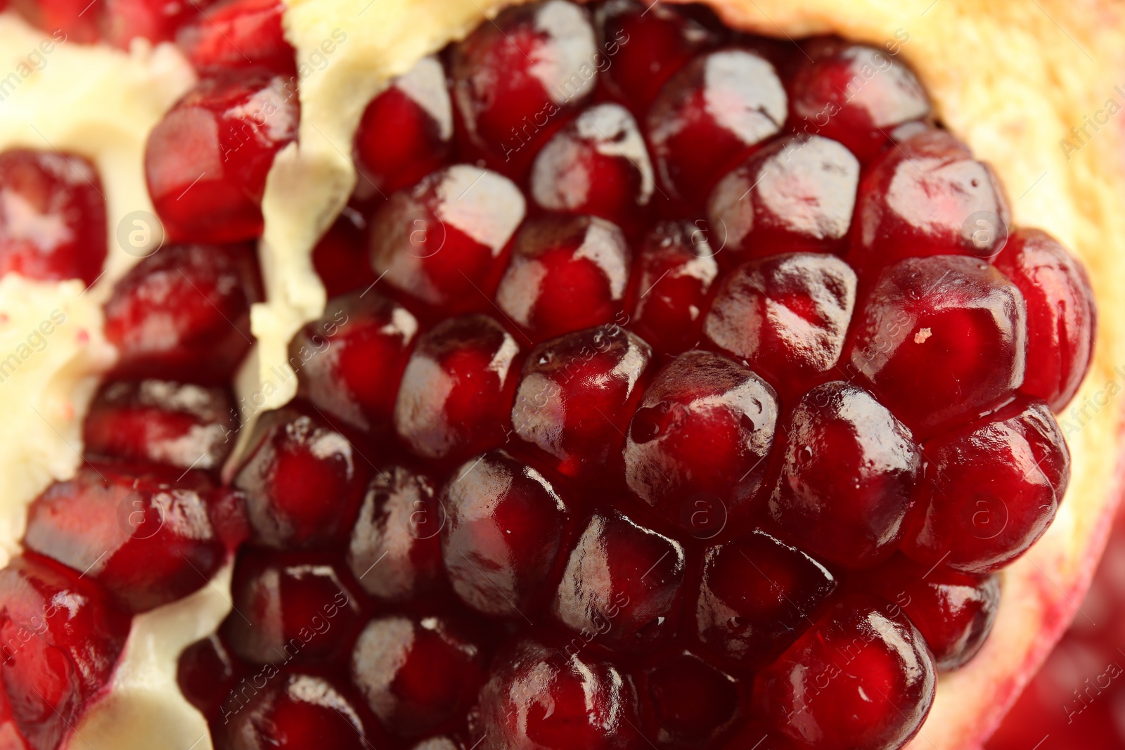 Photo of Ripe juicy pomegranate grains as background, closeup