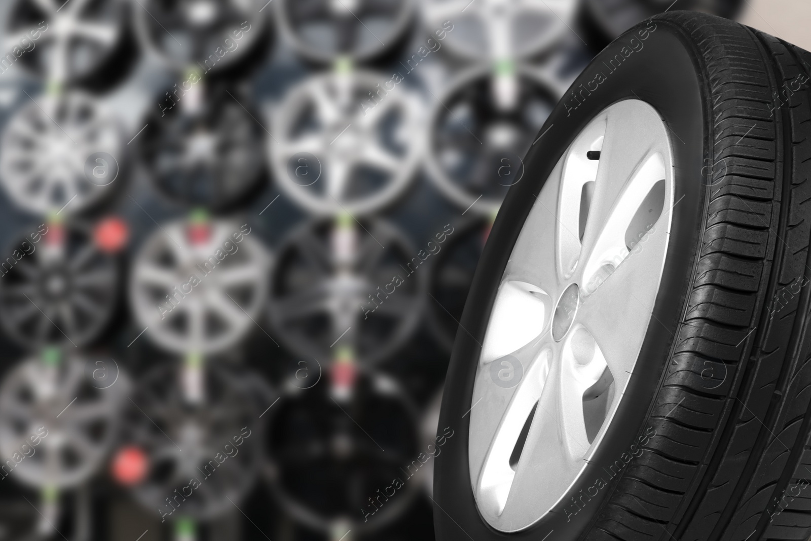 Image of Black car tire in auto store, closeup