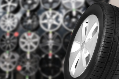 Black car tire in auto store, closeup