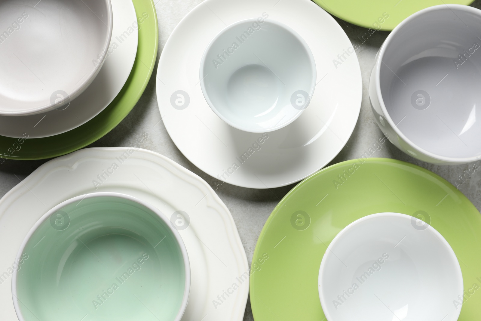 Photo of Beautiful ceramic dishware on light grey table, flat lay