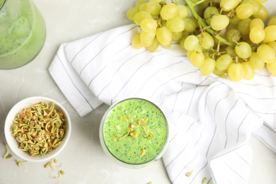 Flat lay composition with green buckwheat smoothie on light grey marble table