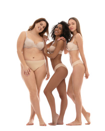 Group of women with different body types in underwear on white background