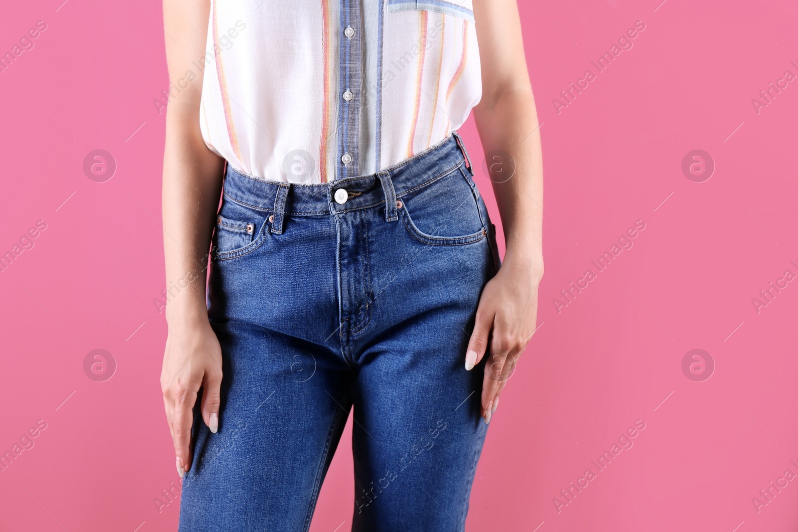 Photo of Woman in stylish blue jeans on color background