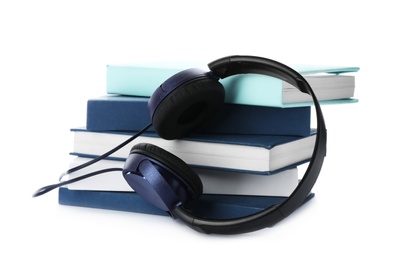 Modern headphones with hardcover books on white background