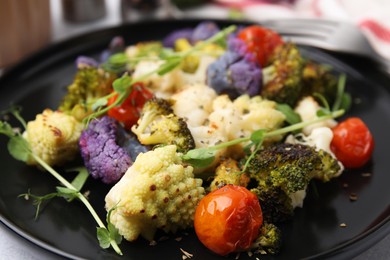 Photo of Delicious salad with cauliflower and tomato on plate, closeup