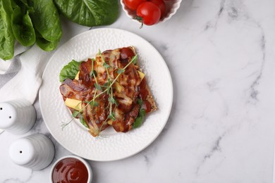 Photo of Tasty sandwich with bacon and microgreens served on white marble table, flat lay. Space for text