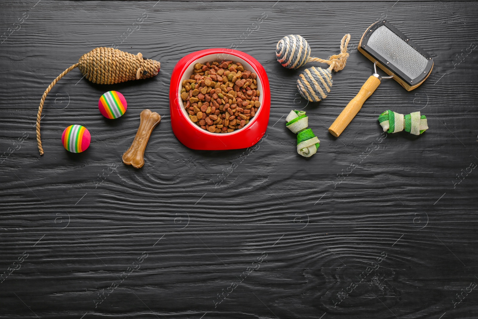 Photo of Flat lay composition with cat accessories and food on dark wooden background