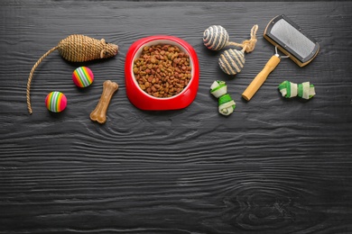 Photo of Flat lay composition with cat accessories and food on dark wooden background