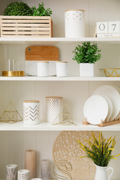 White shelving unit with dishes and different decorative stuff