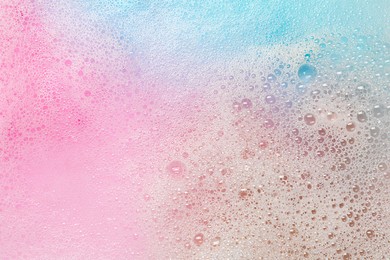 Colorful foam after dissolving bath bomb in water, closeup