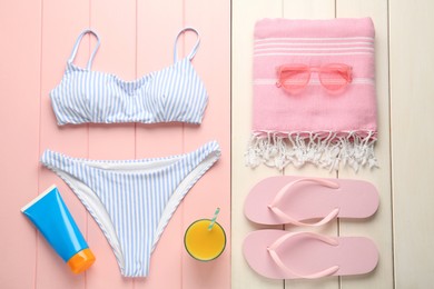 Photo of Flat lay composition with beach objects on color wooden background