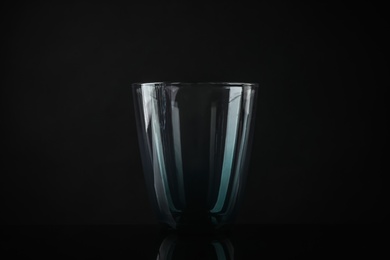 Photo of Elegant empty colorful glass on black background