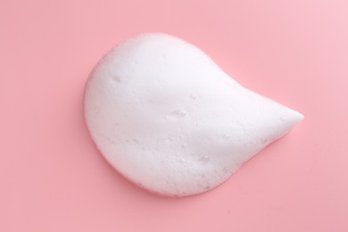 Photo of Sample of fluffy foam on pink background, top view