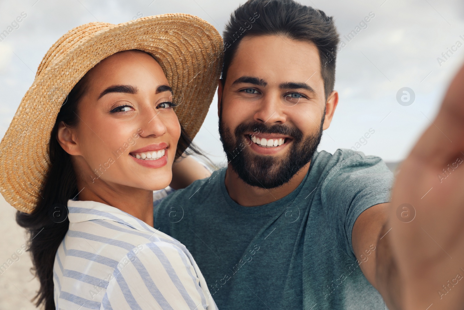 Photo of Lovely couple taking selfie together outdoors on sunny day