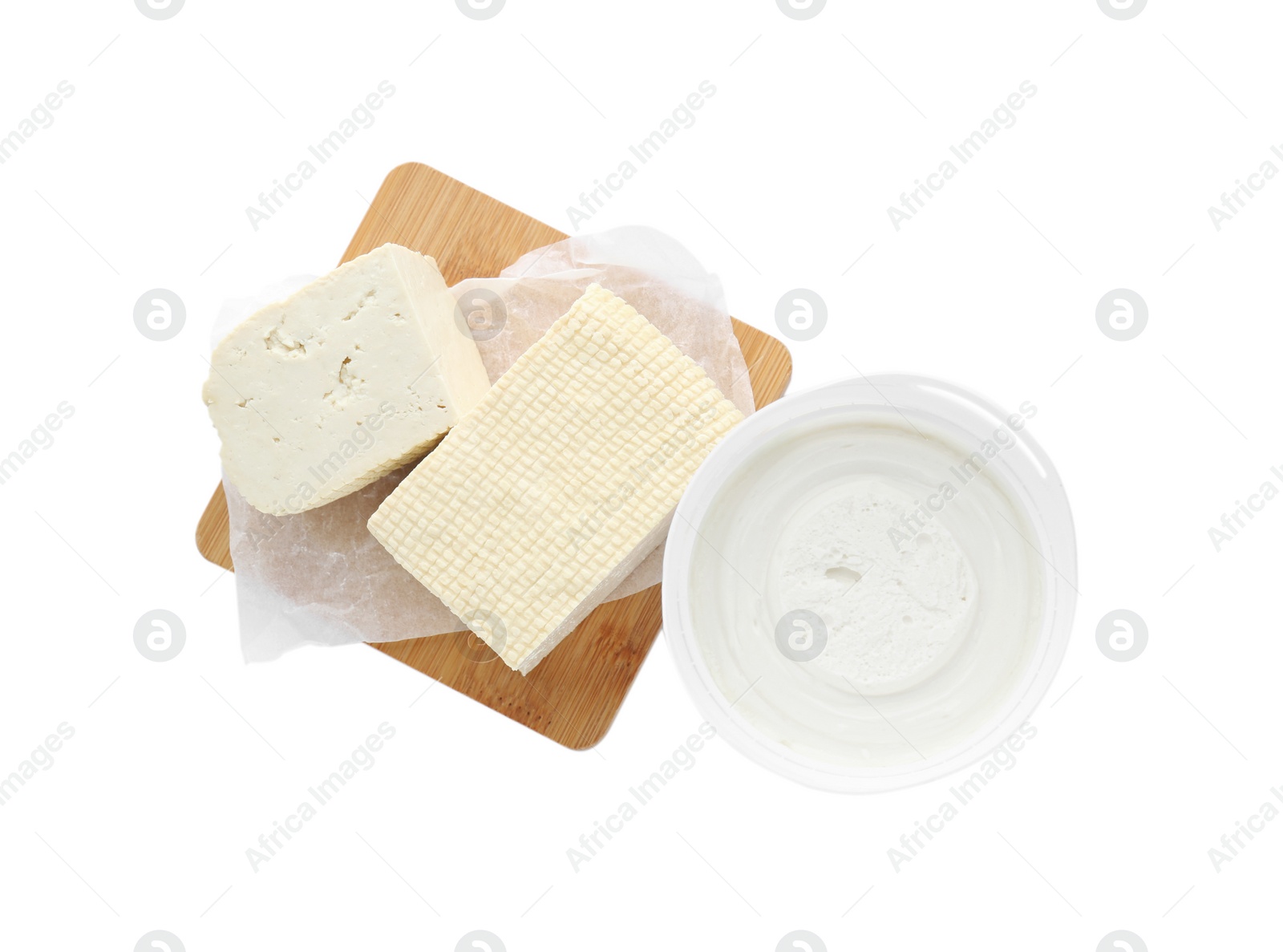 Photo of Tasty tofu and cream cheese on white background, top view