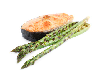 Photo of Tasty salmon steak with asparagus isolated on white